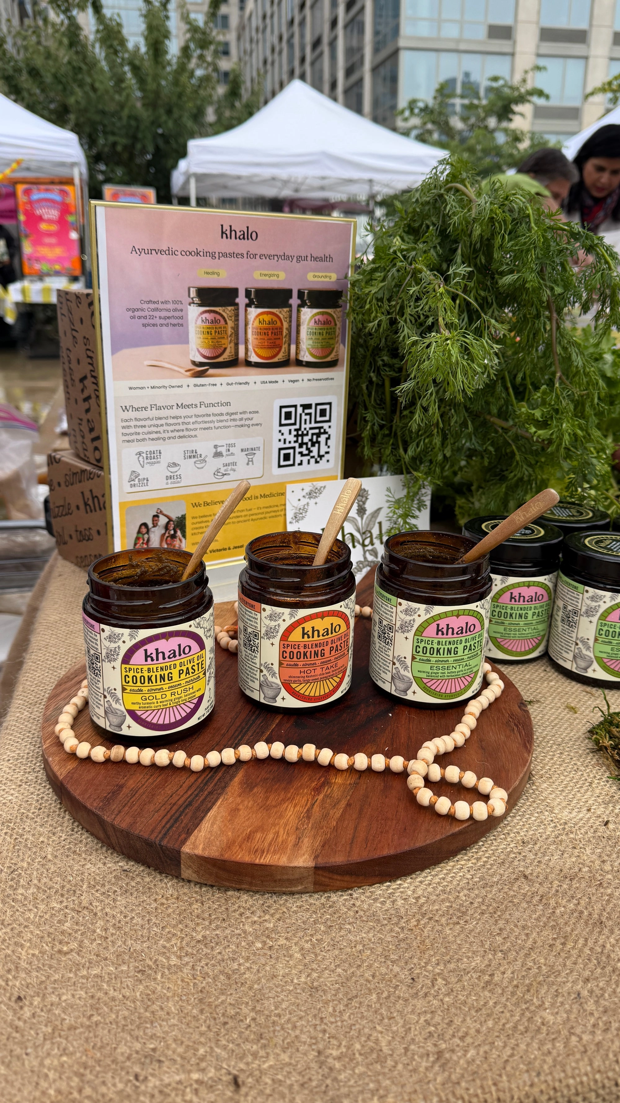 Khalo jars on a round wooden stand wrapped in beads